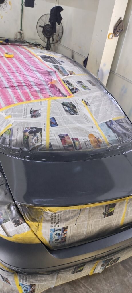 Body painting preparation with protective newspaper and masking tape