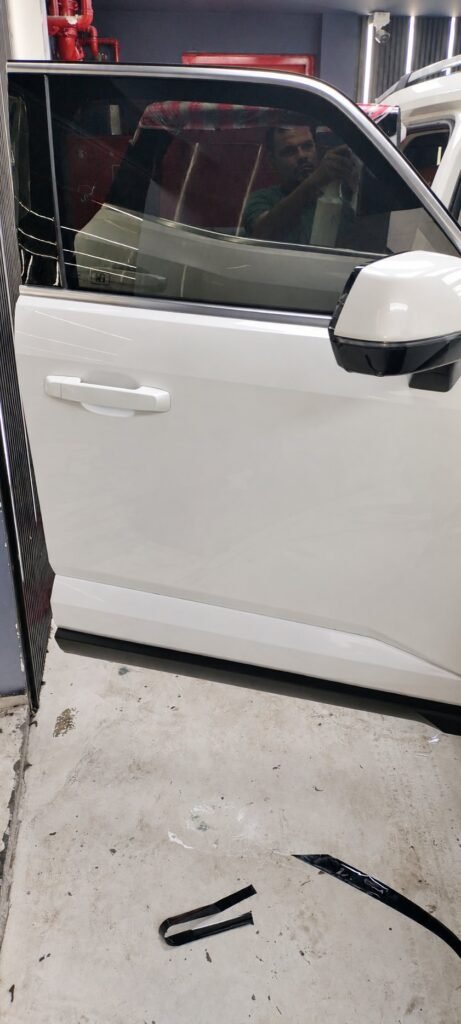 White SUV door and mirror paintwork at the Wrapex workshop